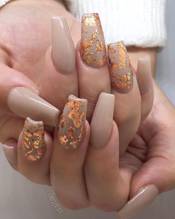 Quinceanera image: Nail designs, a woman's hand with a manicured manicure featuring gold foil