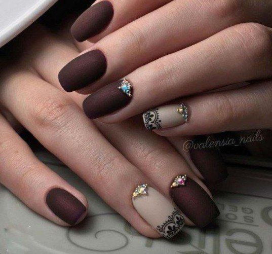 A classy Quinceanera nail art design featuring a woman's hands with a brown and white manicure