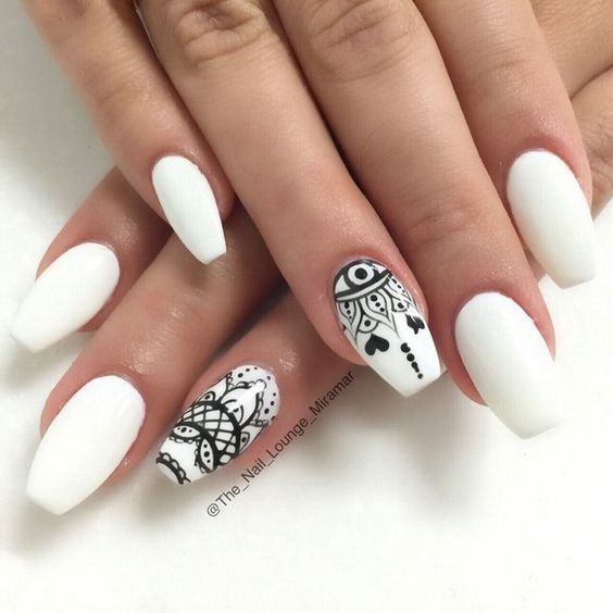 Quinceanera image of a woman's hand with black and white tribal nail art designs