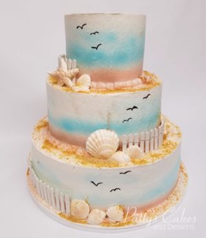 A Quinceanera sugar cake, a three tiered cake decorated with seashells and seagulls