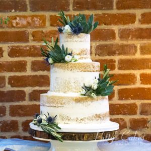 Quinceanera cake: Patty's Cakes and Desserts presents a three-tiered Quinceanera cake adorned with greenery on top