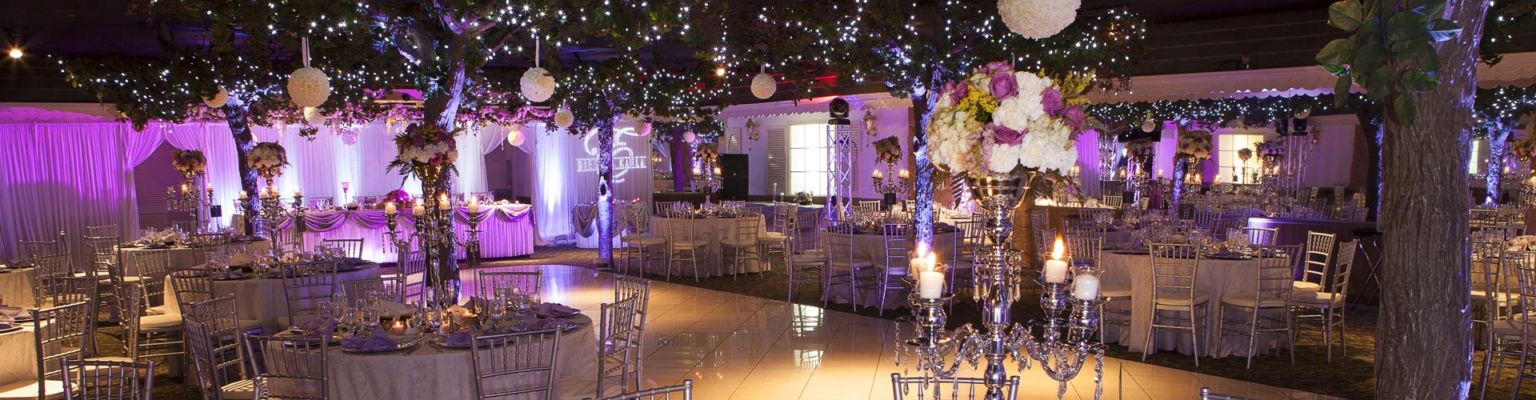 A Quinceanera celebration held at Royal Garden Banquets & Catering. The image shows a beautifully decorated function hall with tables.
