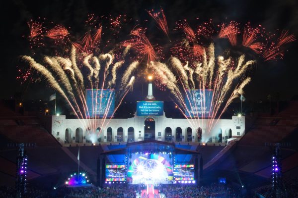 Large crowd of people watching fireworks in the sky at the LA Memorial Coliseum on the 4th of July