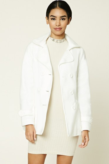 A Quinceanera dressed in a stylish white coat and dress, modeling a fashionable T-shirt.