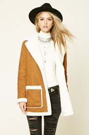 Quinceanera fashion model wearing a brown and white coat