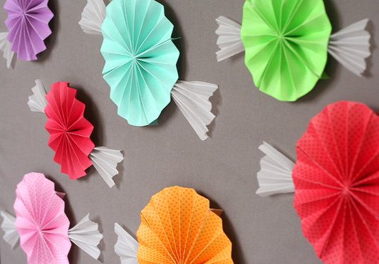 A beautiful arrangement of petal origami and a bunch of paper flowers on a wall, perfect for a Quinceanera celebration.