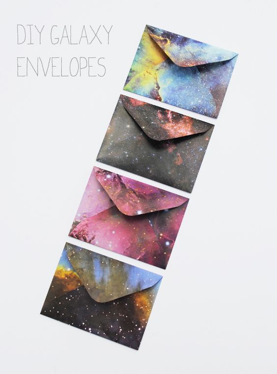 Quinceanera-themed image: A set of four galaxy envelopes on a white surface