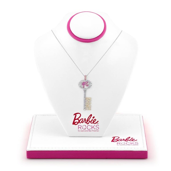 A Quinceanera-themed image featuring a display of Barbie jewellery, including a necklace with a key pendant.