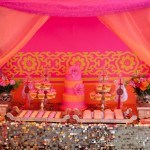 Quinceanera Party, a table topped with lots of desserts under a pink canopy