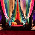 Quinceanera mehndi stage decorations, a stage decorated with colorful drapes and pillows