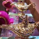 A Quinceanera party with a glass table topped with a golden lamp.