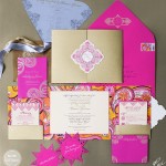 A pink and gold Quinceanera invitation with a ribbon