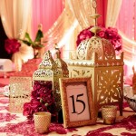Quinceanera, a table topped with a table cloth covered in pink flowers with Moroccan decor ideas