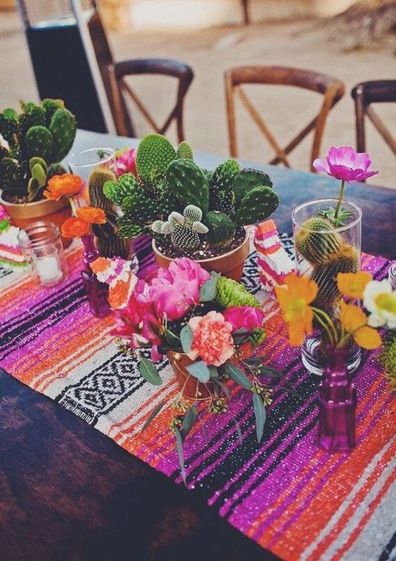 A Quinceanera themed Mexican wedding with a table adorned with vases filled with flowers
