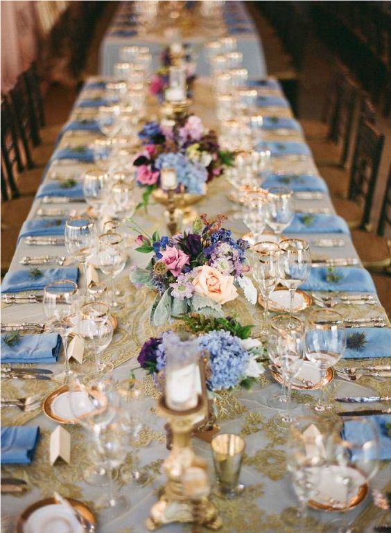 Quinceanera accent colors. A long table is set with blue and white place settings.
