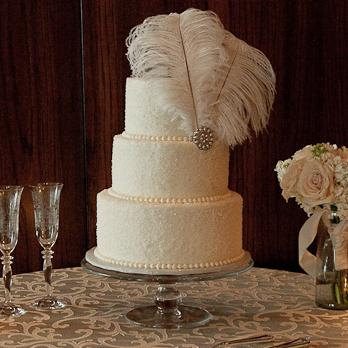 Quinceanera cake, a white cake with feathers on top