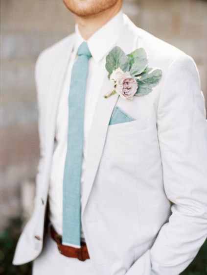 Quinceanera: A man in a pastel suit, wearing a white suit and blue tie.