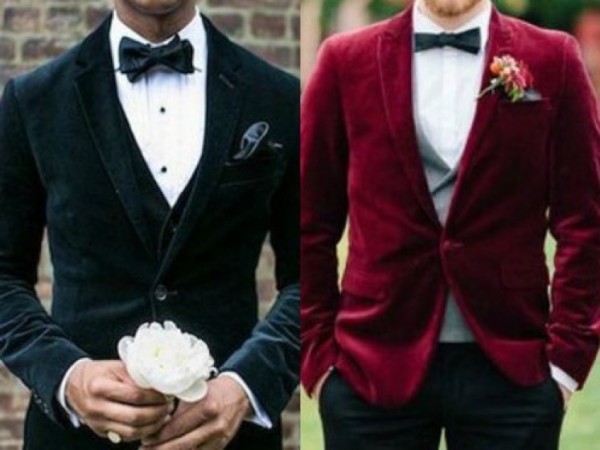 Men wearing black velvet blazers at a Quinceanera, two men in tuxedos standing next to each other