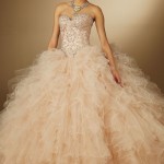 A woman in a ball gown posing for a picture in a Quinceanera gown Haute couture