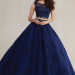 Two piece Quinceanera dresses, a woman in a blue ball gown posing for a picture