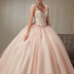 A woman posing for a picture in a Quinceanera ball gown