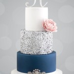 Quinceanera blue and silver cake with icing, a three-tiered cake with a rose on top