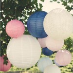 A Quinceanera celebration with a tree decorated with paper lanterns