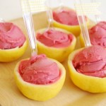 Quinceanera themed image: a wooden cutting board topped with lemons covered in pink frosting, representing easy snack recipes Dessert