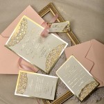A group of Quinceanera invitation cards and envelopes, featuring a pink color theme, placed on a table.