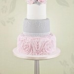Quinceanera cake, a three tiered cake with pink flowers on top
