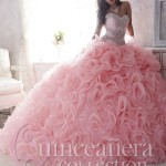 Quinceañera dresses, a woman in a pink dress posing for a picture