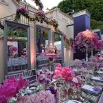 A beautiful Quinceanera floral arrangement with pink flowers on a long table.