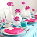 A table set with pink and blue place settings, featuring a Tiffany blue and pink Quinceanera theme
