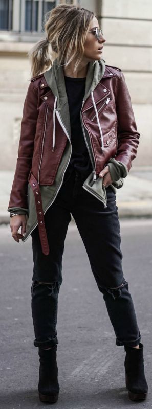 A Quinceanera woman wearing a red leather jacket and black jeans posing in St. James's Park