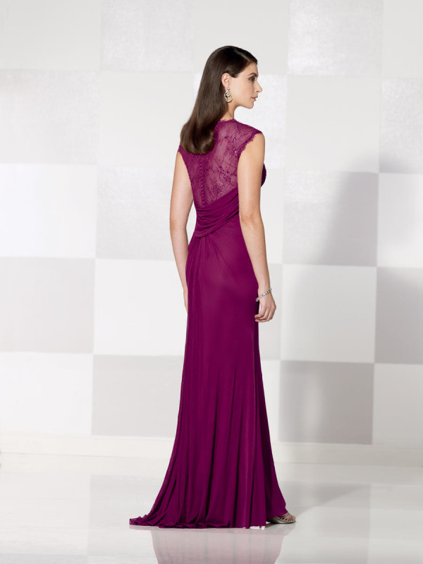 A woman in a purple Quinceanera gown standing in a room