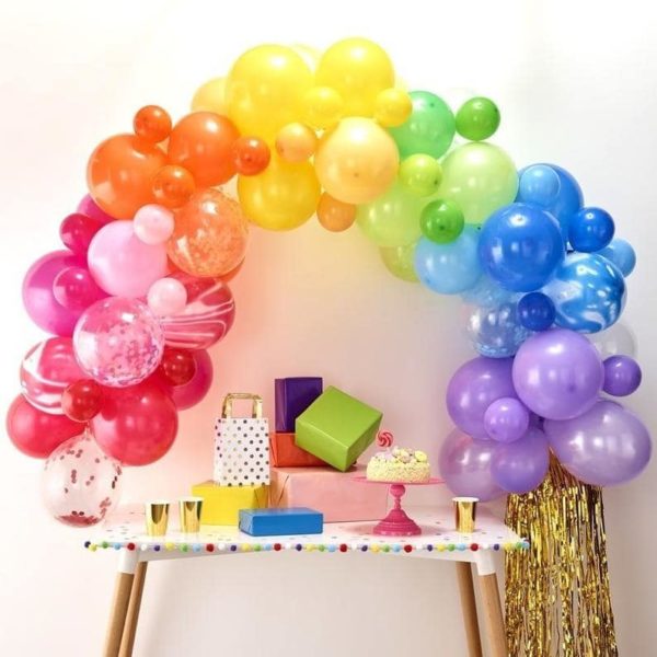 A Quinceanera image featuring a ginger ray balloon arch kit. The image shows a table topped with a bunch of balloons.