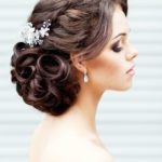 Quinceanera hairstyle with a bun and a woman wearing a Quinceanera hair comb