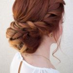 A woman with red hair and a white top, showcasing a beautiful Quinceanera hairstyle.