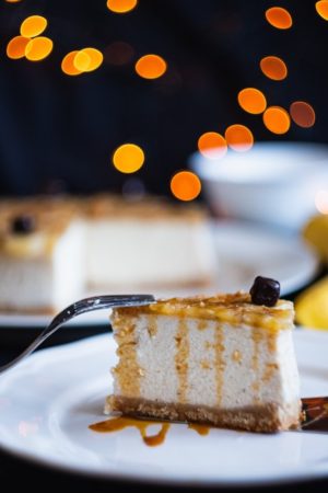A slice of cheesecake on a plate with a fork, perfect for a Quinceanera celebration