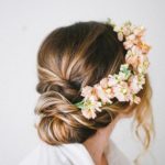A woman with teal hair wearing a flower crown, representing Quinceanera.
