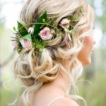 Quinceanera hairstyle with a flower crown, a woman wearing a flower in her hair