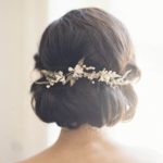 A close up of a woman with a Quinceanera hairstyle, wearing a hair comb