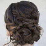 Close up of a woman's hair with curls, featuring a Quinceanera updo comb