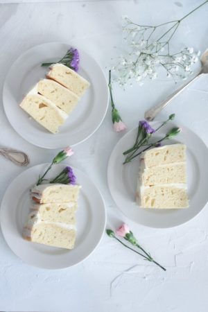 Quinceanera: moist vanilla cake, three slices of cake on white plates with flowers