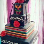A Quinceanera themed three tiered cake with a bird on top