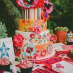 Colorful Mexican Quinceanera cake, a multicolored cake on a table outside