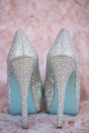 Close up of a person wearing blue Quinceanera heels