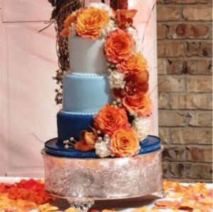 Quinceanera cake, a three tiered cake with orange and blue flowers