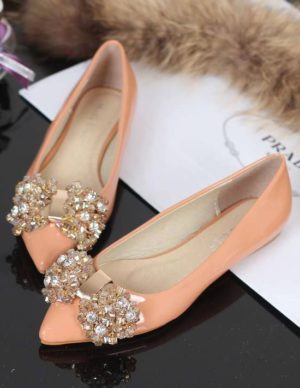 A pair of high-heeled shoes for Quinceanera sitting on top of a table