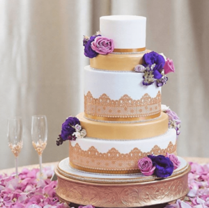 Quinceanera cake, a three-tiered cake with purple and white flowers